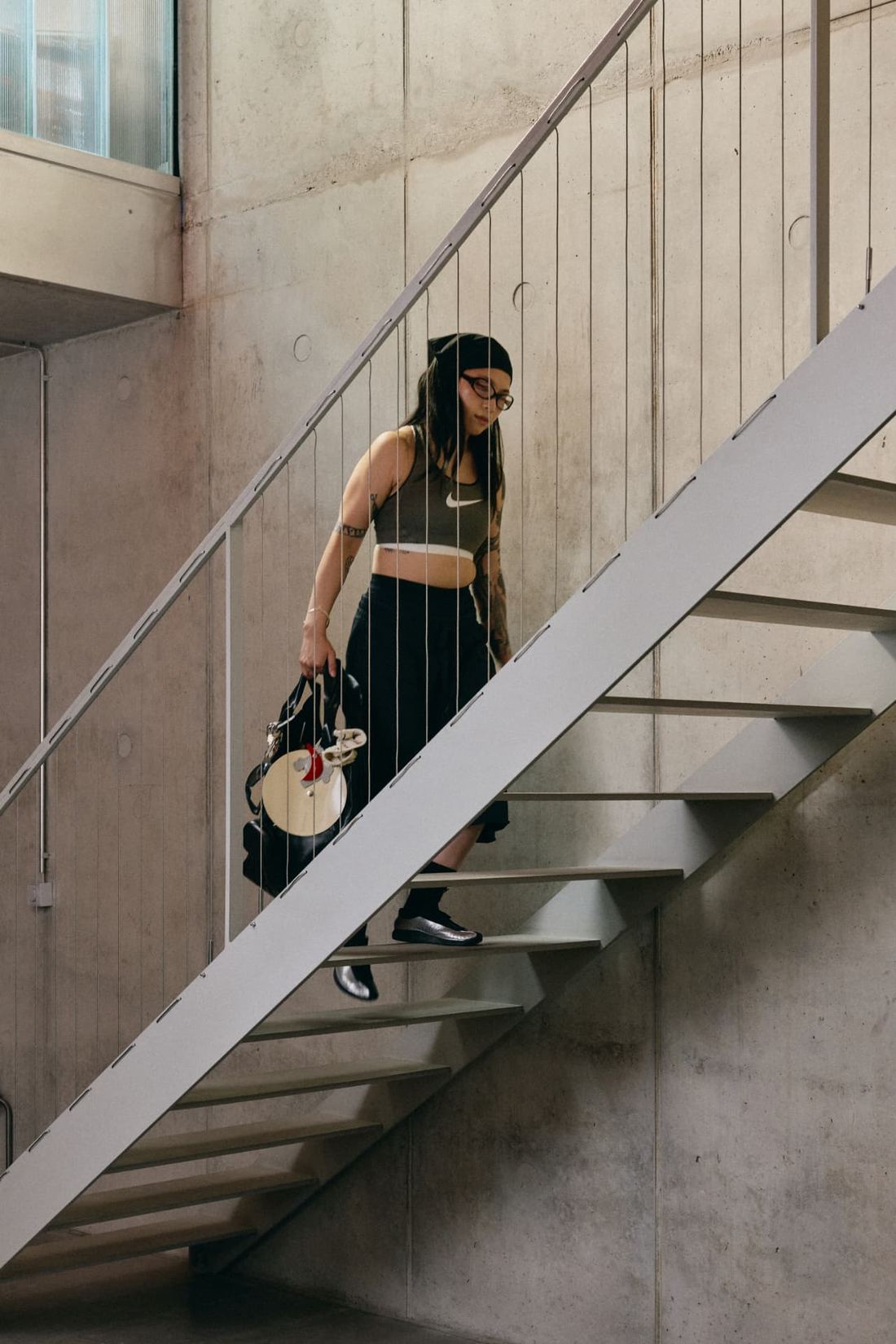 A client carrying the Framework bag while walking down the studio stairs