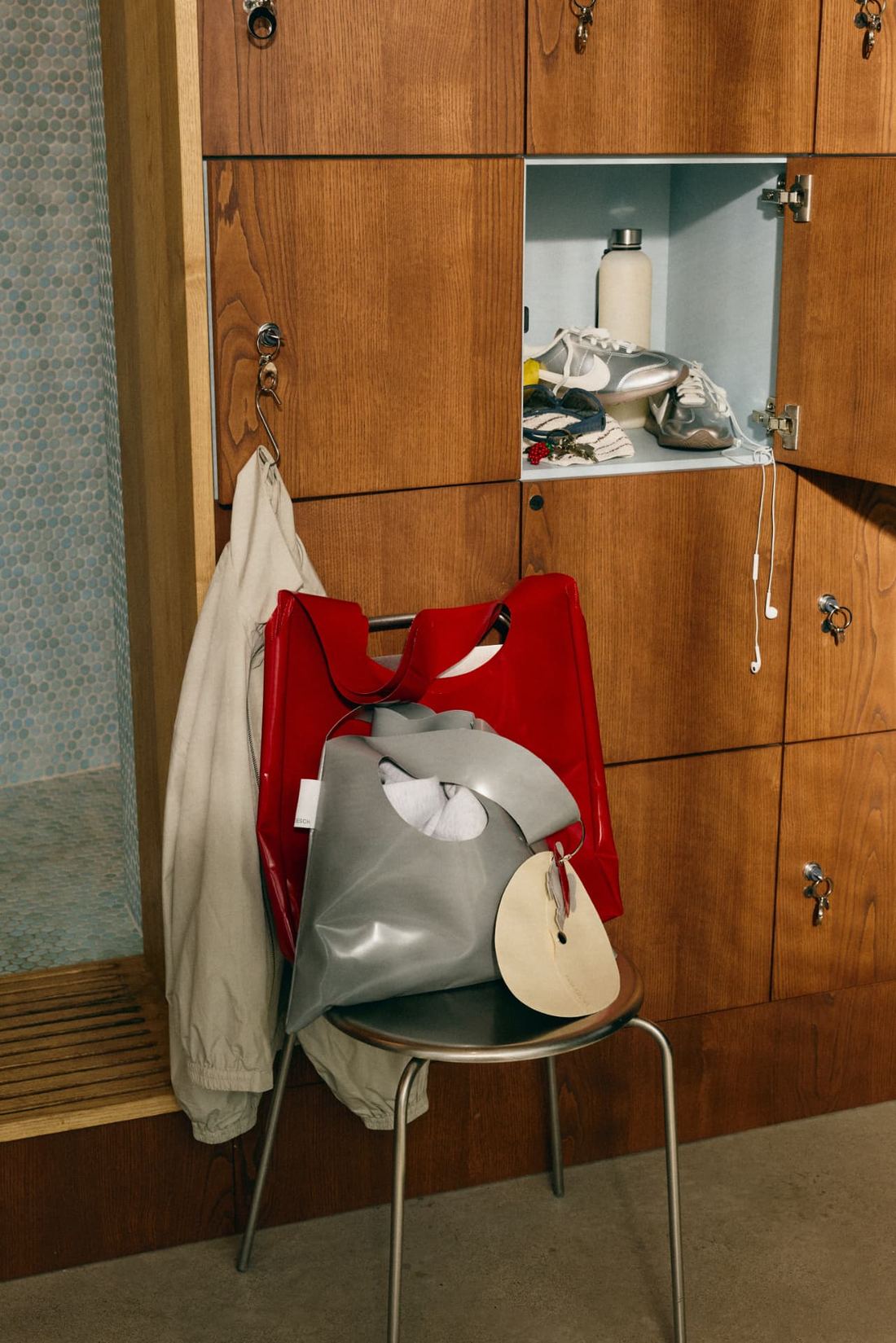 The red and grey Framework bag on a stool in the studio changing room
